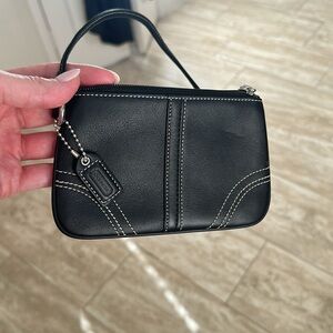 Black colored Coach wristlet. Used a few times but is almost perfect condition.